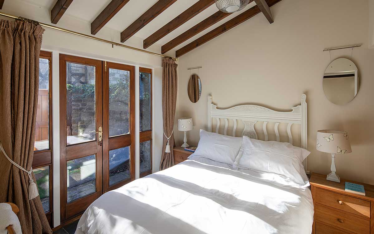 Stable Block downstairs double bedroom with patio doors to the garden