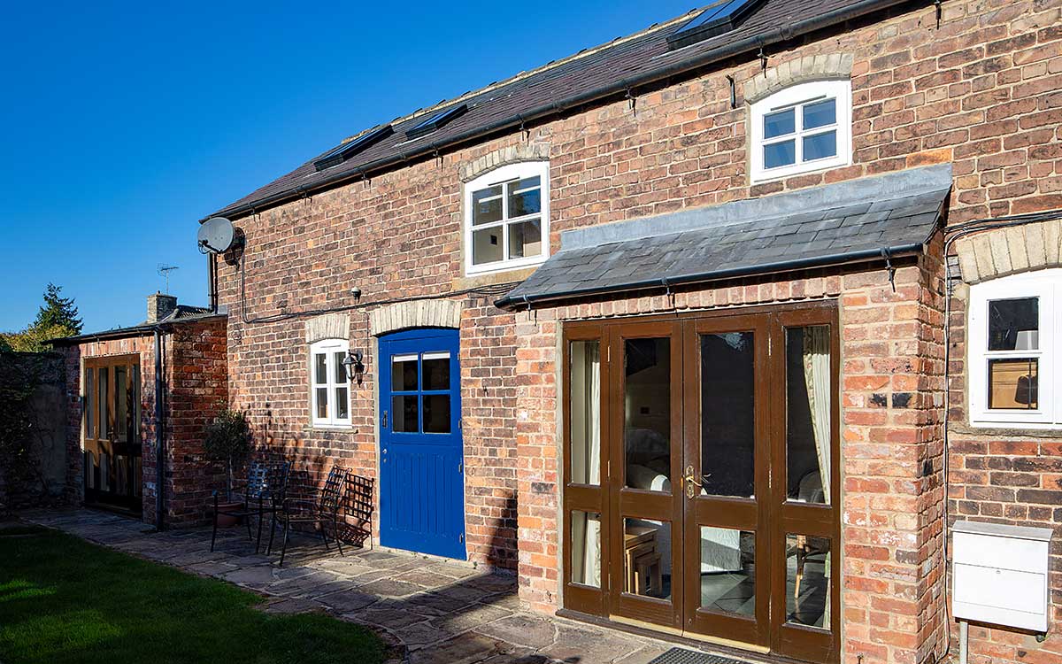 Stable Block exterior with doors closed on a sunny day